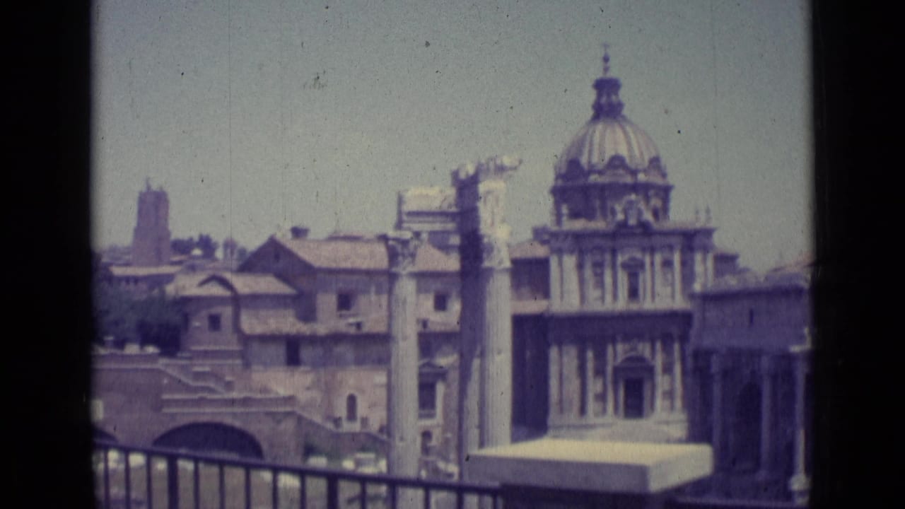 Domed church facade and surrounding Vatican architecture seen from a distance.