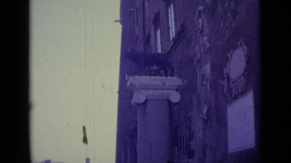 1962 Vatican City travel frame with a column base, textured wall, signs, pale open background, and visible dust on the film scan.