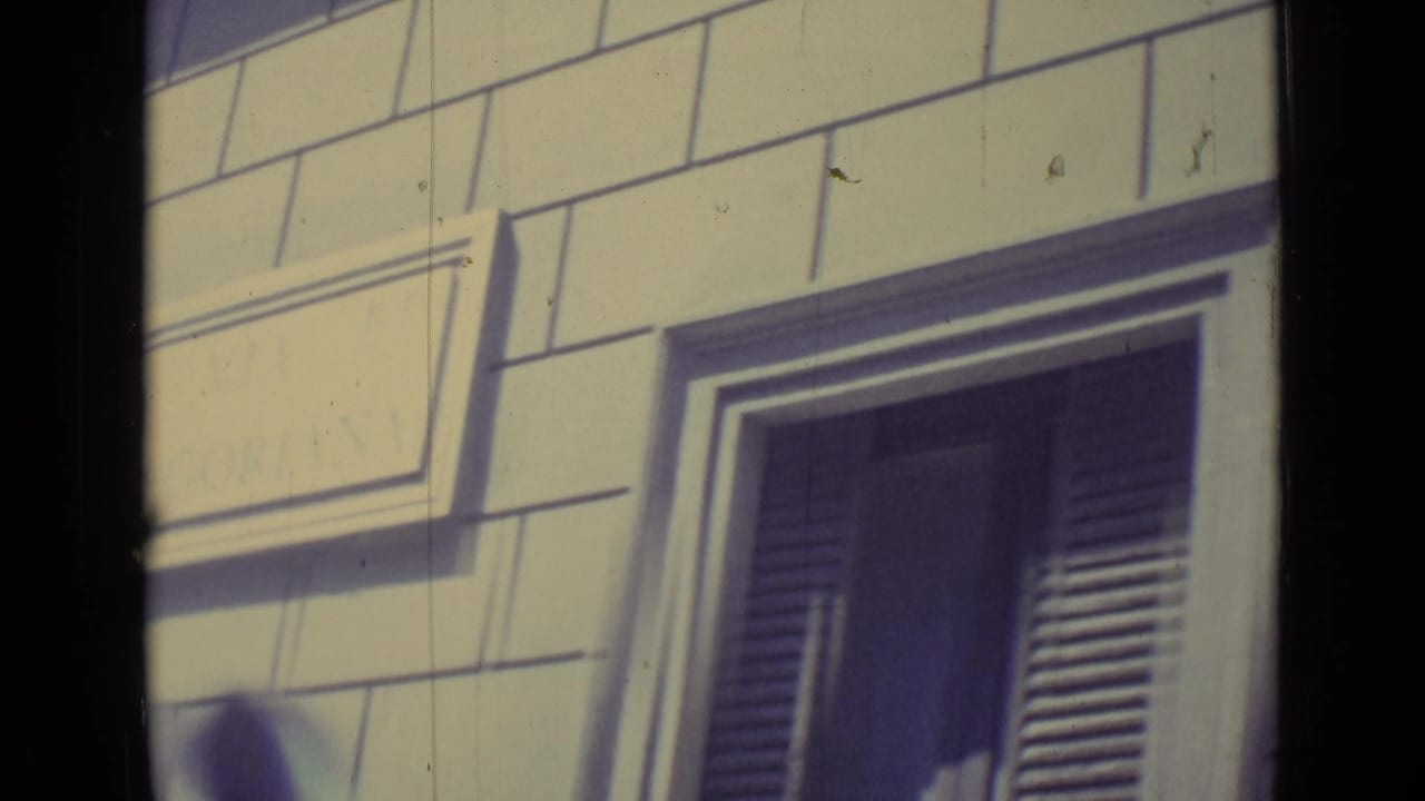 The final frame centers on a shuttered window and block-pattern facade in the 1962 Vatican City travel footage.