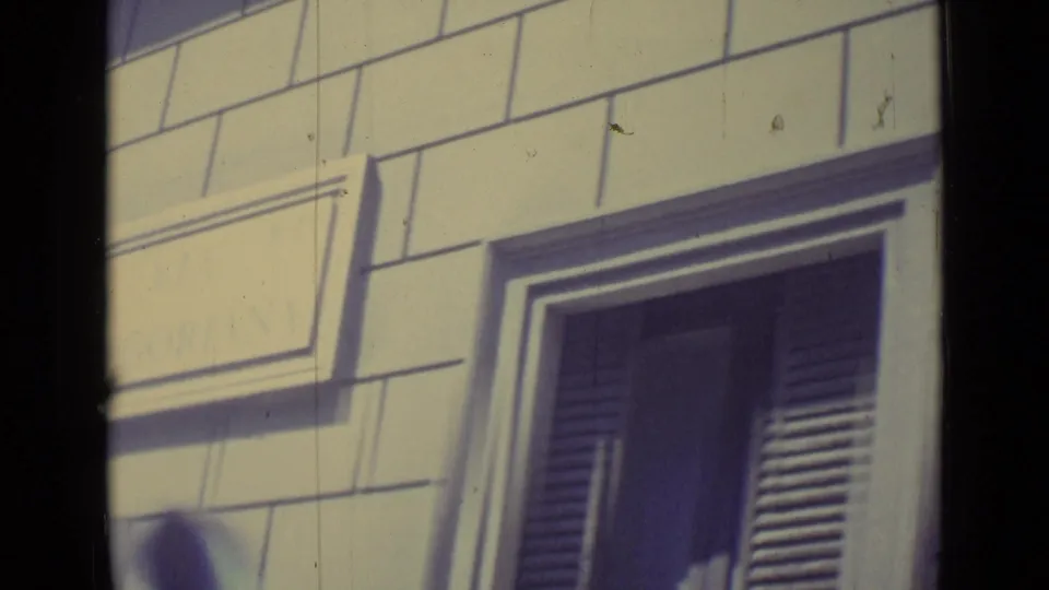 The final frame centers on a shuttered window and block-pattern facade in the 1962 Vatican City travel footage.