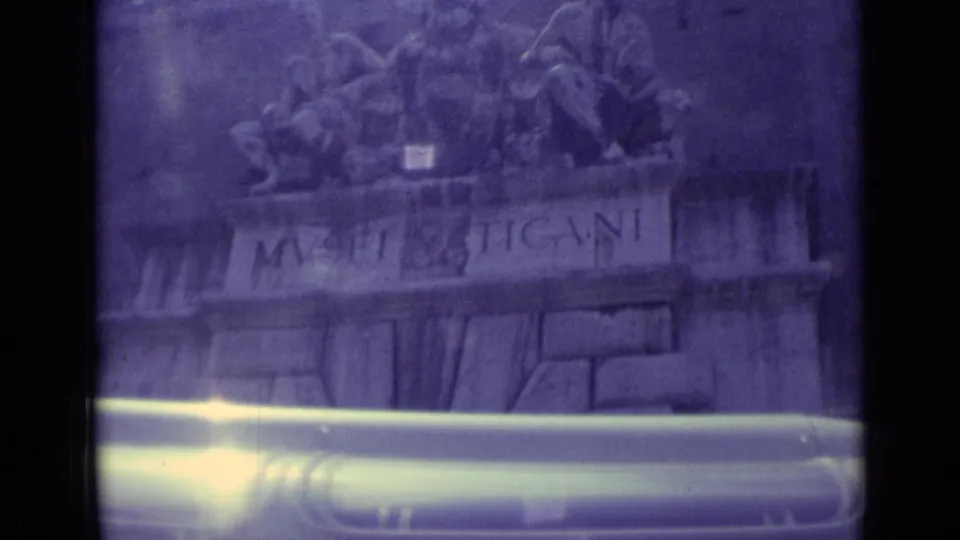 1962 Vatican City home-movie frame showing the Musei Vaticani inscription, upper entrance sculpture, and a car passing along the bottom edge.