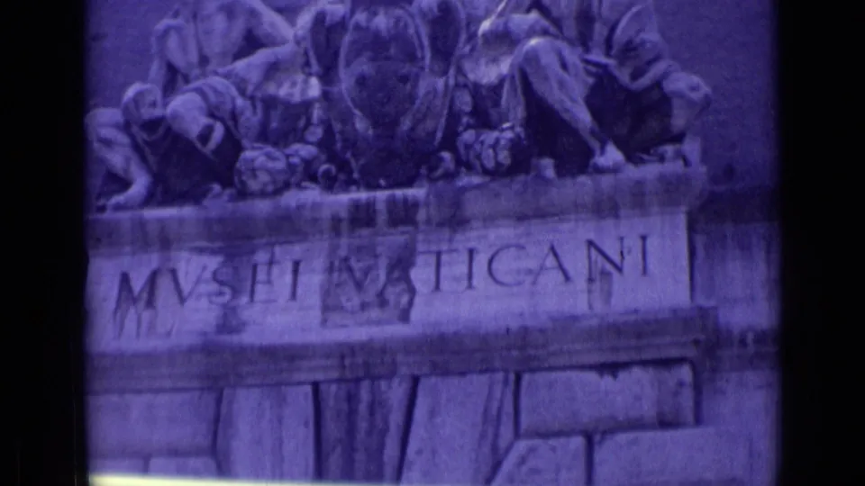 Purple-tinted 8mm view of the Vatican Museums entrance inscription, relief sculpture, and carved stone facade in Vatican City.