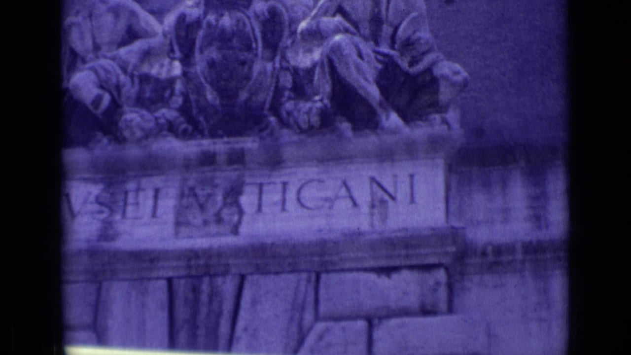 1962 8mm Vatican City frame with a cropped view of the Vatican Museums inscription and sculpture on the entrance facade.