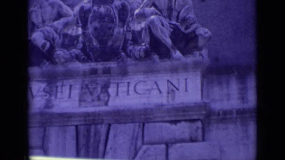 1962 8mm Vatican City frame with a cropped view of the Vatican Museums inscription and sculpture on the entrance facade.