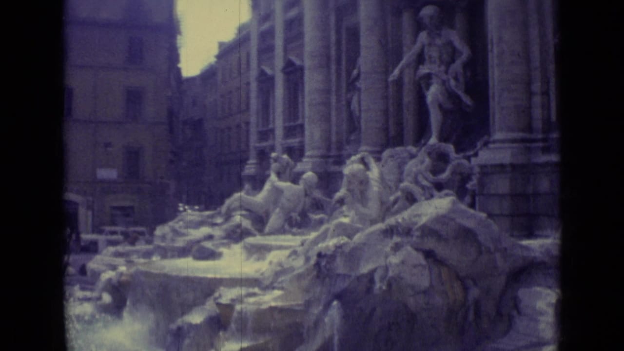 1962 Vatican City frame showing a sculptural fountain with carved figures, rocky forms, water, and tall surrounding architecture.