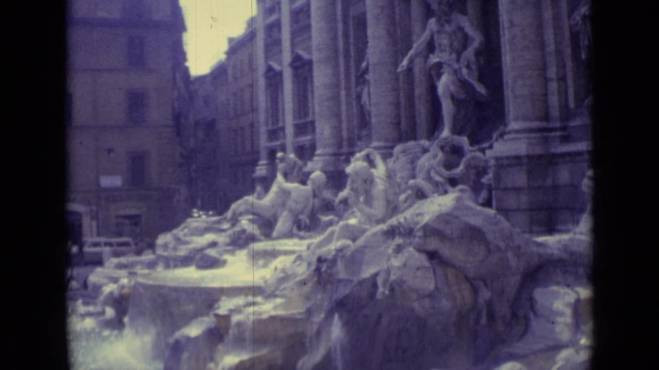 Trevi Fountain sculptures and flowing water seen from a close visitor angle.