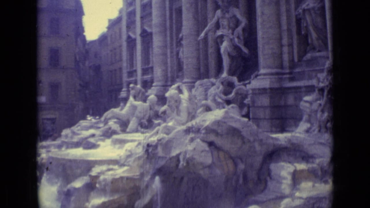 Cataloged 1962 travel footage frames Trevi Fountain figures, rock formations, and vertical columns in soft faded color.