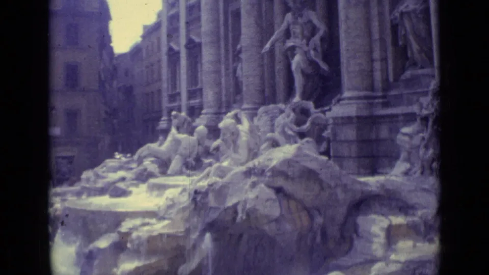 Cataloged 1962 travel footage frames Trevi Fountain figures, rock formations, and vertical columns in soft faded color.