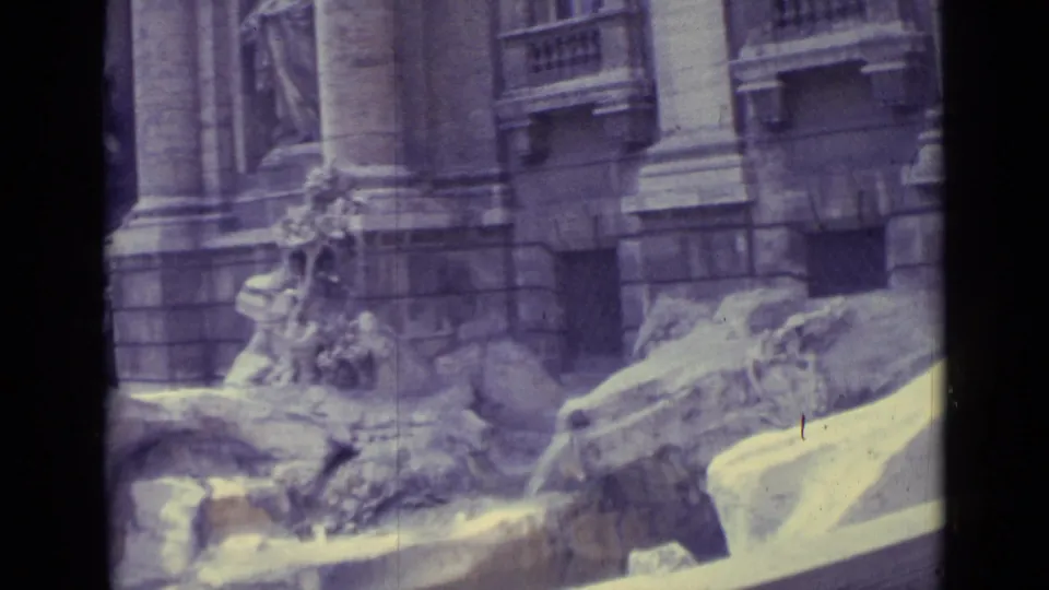 Aged 8mm frame of Trevi Fountain stonework and statuary, with a dark vertical strip from the contact-sheet layout.