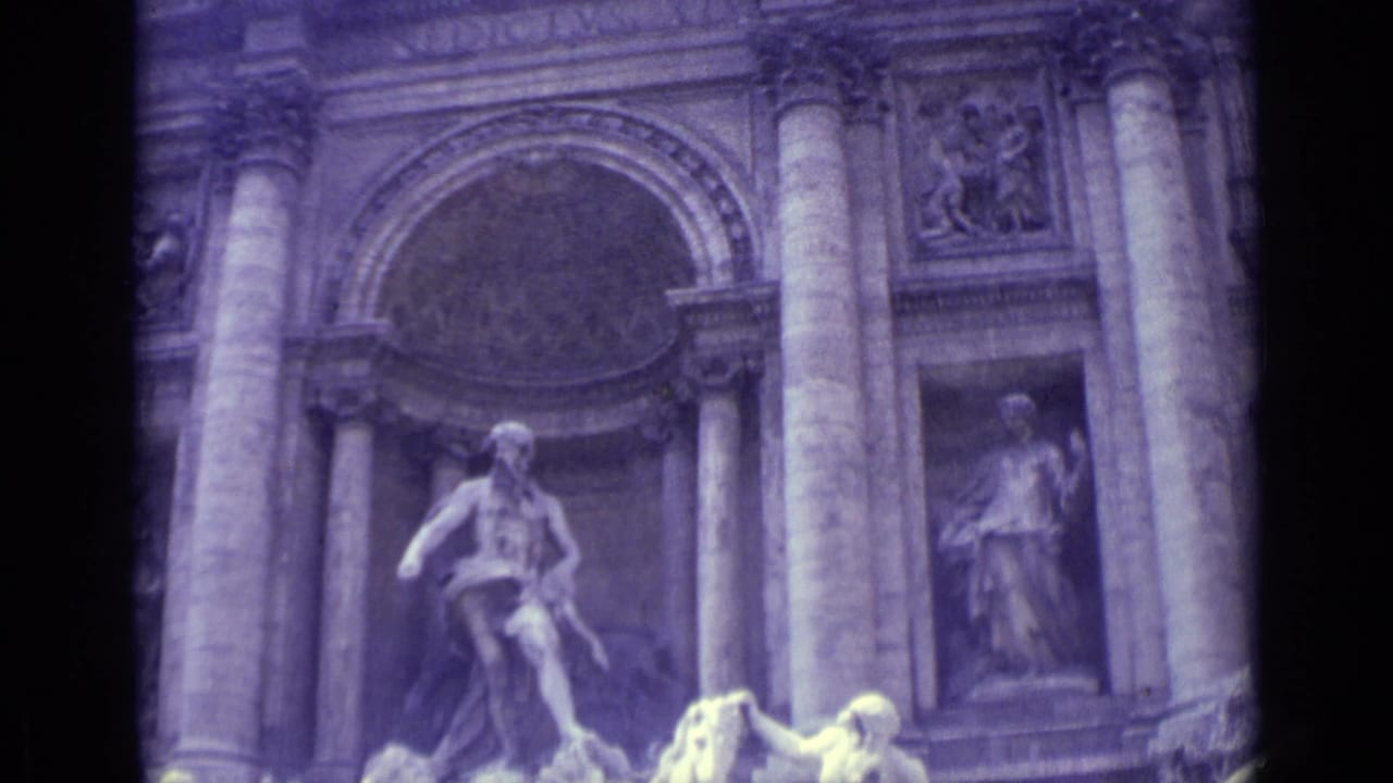 Trevi Fountain facade with central figure above rocks and water entering frame.