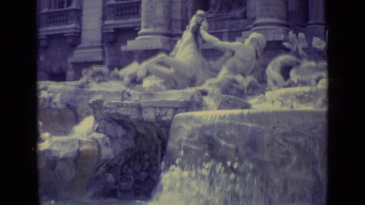 1962 8mm travel frame of carved fountain figures, horses, columns, and water flowing over a stone ledge.