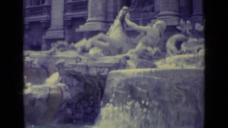 1962 8mm travel frame of carved fountain figures, horses, columns, and water flowing over a stone ledge.