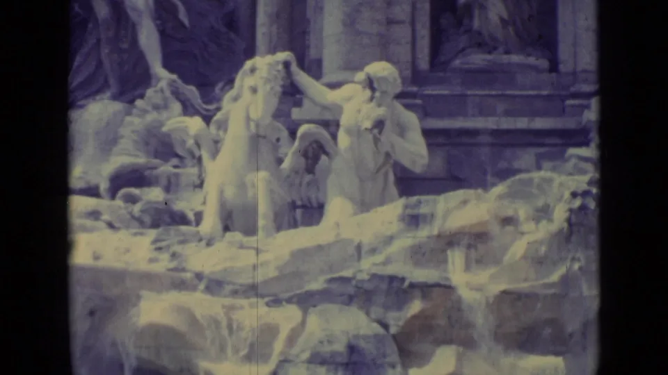 Vatican City fountain detail with carved figures and horse sculptures, captured on faded early-1960s 8mm film.