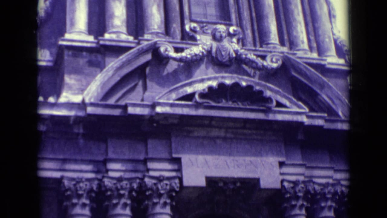 A purple-shifted 1962 Vatican City close-up shows carved architectural ornament, columns, and an arched facade section.