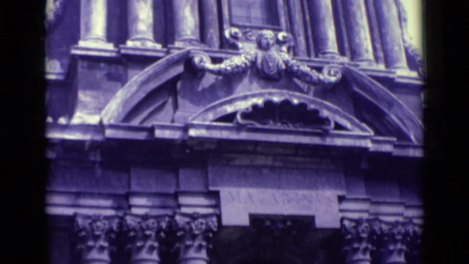 A purple-shifted 1962 Vatican City close-up shows carved architectural ornament, columns, and an arched facade section.
