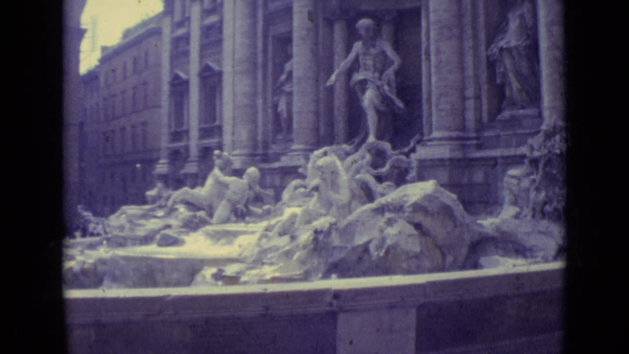Final 1962 travel frame holds on the Trevi Fountain sculptures and architectural facade, with soft color and visible film grain.