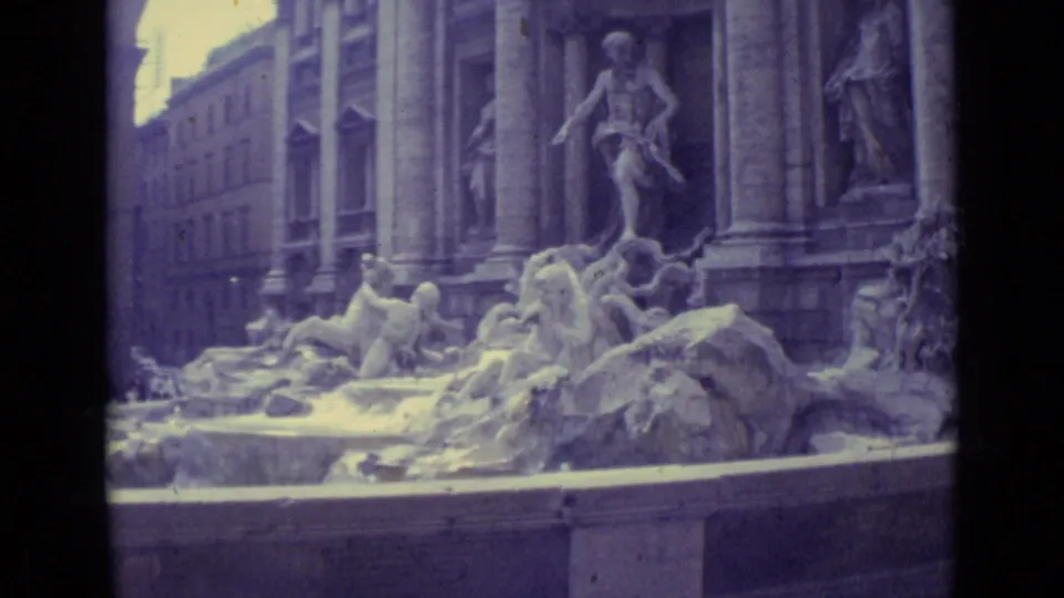Final 1962 travel frame holds on the Trevi Fountain sculptures and architectural facade, with soft color and visible film grain.