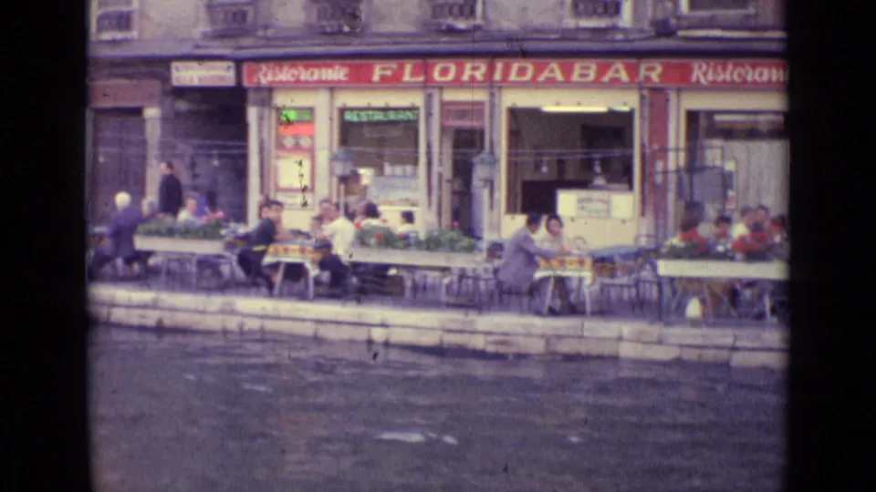 Closer 1962 Venice view of waterfront cafe tables beneath Floridabar Ristorante signage, with diners seated beside the canal.