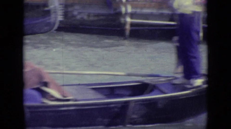 1962 Venice 8mm frame showing a gondola near canal water with a standing gondolier cropped at the upper edge.