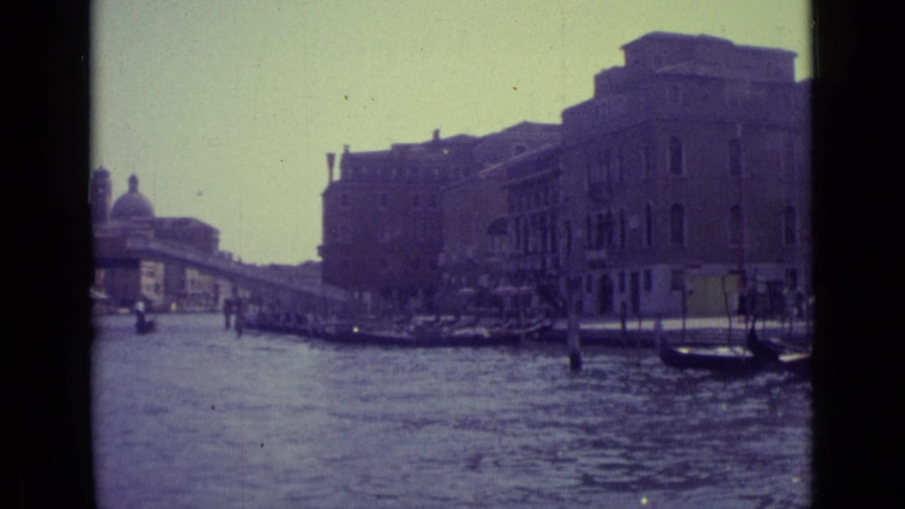 Grand Canal view with gondolas and large Venetian buildings along the water.