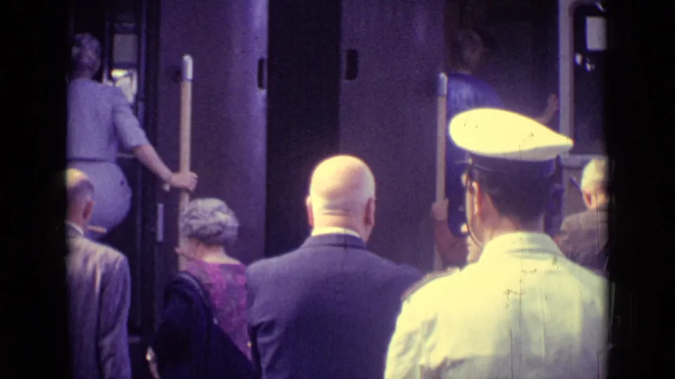 At the end of the 1962 Venice clip, passengers continue boarding while a uniformed railway worker stands in the foreground.