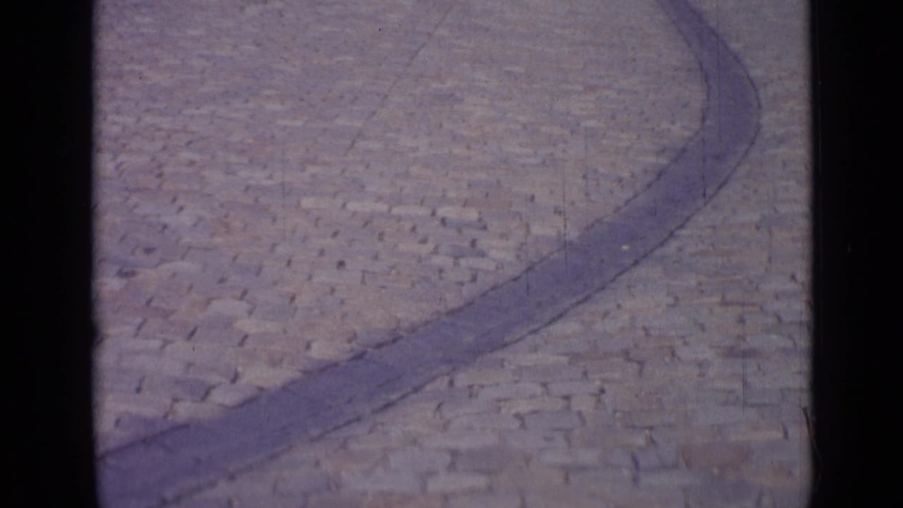 Cobblestone paving and curved stone line seen from a high, close angle.