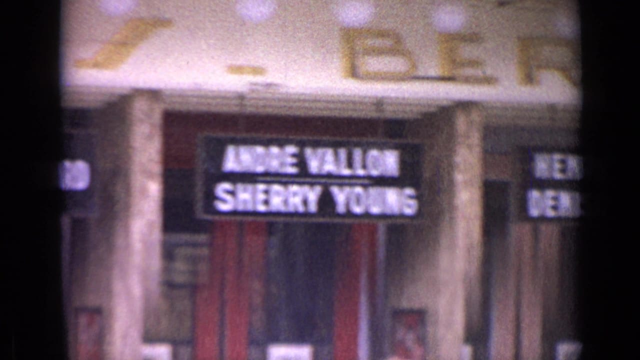 Soft 8mm view of a theater entrance with marquee names Andre Vallon and Sherry Young.