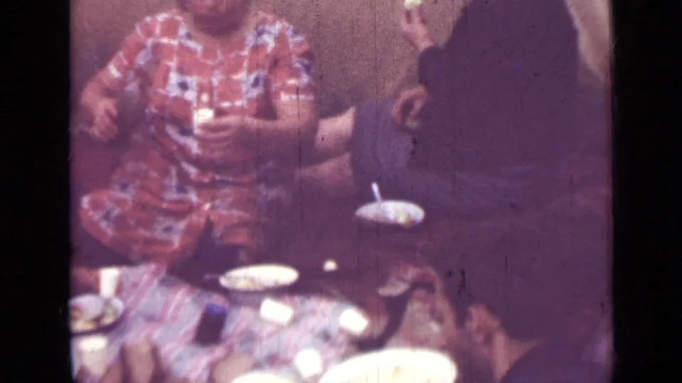 1967 Saint Petersburg private interior with people gathered tightly around a table of cups and plates in soft 8mm color.