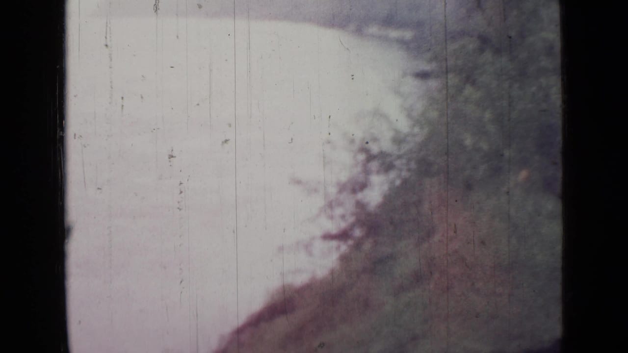 Pale water or sky beside a sloping wooded bank with dark 8mm frame edges.