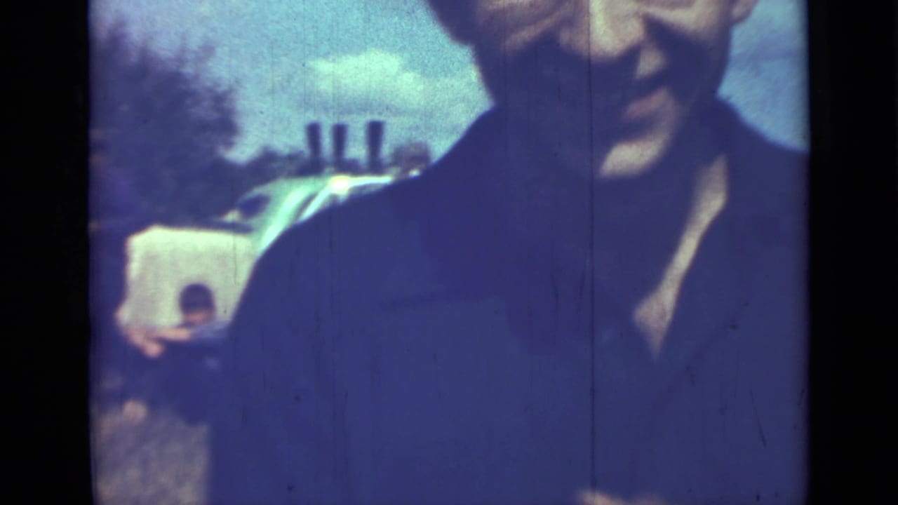 Close view of a man in a dark shirt raising his hands toward the camera.