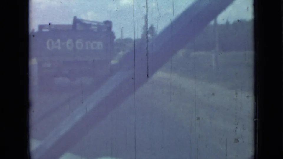 Rear view of a truck with visible numbers on a 1967 Saint Petersburg road, partly obscured by the filming vehicle and worn 8mm texture.