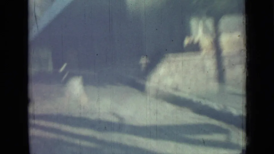 1967 Saint Petersburg frame showing a soft, bluish view of steps, low walls, building exterior, and distant indistinct pedestrians.
