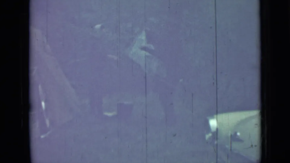 1967 Saint Petersburg 8mm frame showing a pale classic car partially hidden by dark framing, reflections, and blue-purple film cast.