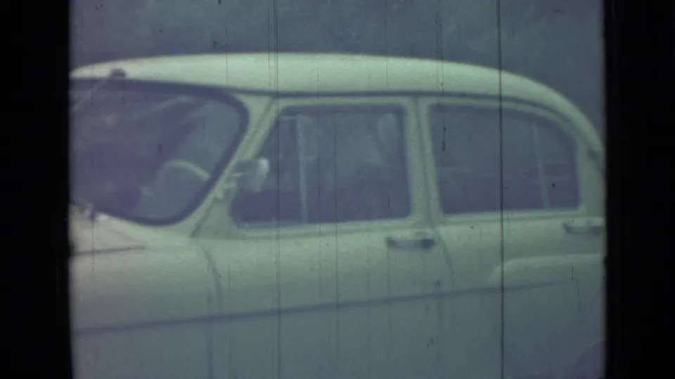 1967 Saint Petersburg 8mm frame showing a pale classic car in side profile, with windows, roofline, and soft aged-film texture.