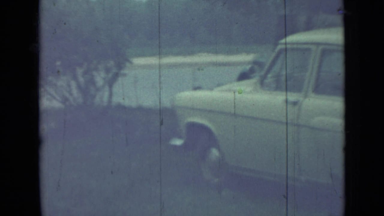 1967 Saint Petersburg frame showing the front side of a pale parked sedan, partly cropped by the 8mm film gate.