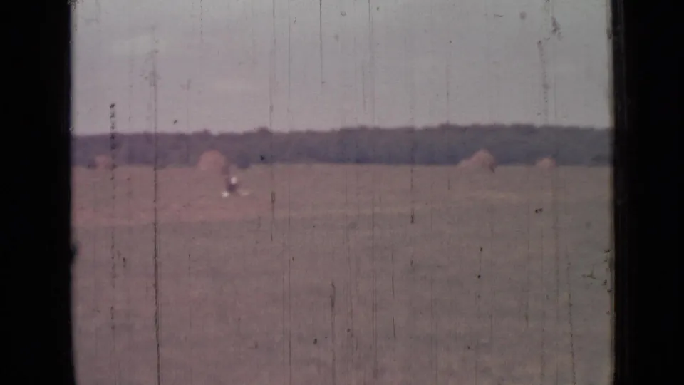 Wide 1967 8mm field view from the Saint Petersburg metadata, with a distant treeline, hazy sky, and visible film wear.