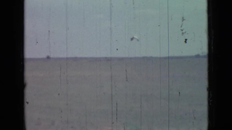 1967 8mm home-movie view near Saint Petersburg showing flat water, pale sky, and a low distant horizon with faint trees.