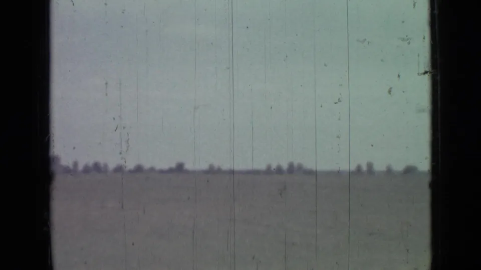 Final 8mm frame shows the same Saint Petersburg coastal horizon with muted color, dust, scratches, and no visible face in the still.