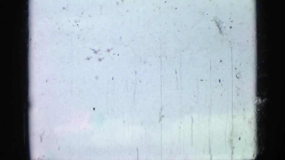 A pale, mostly blank 8mm frame shows exposure shift, dust, and scratches at the end of the garden clip.