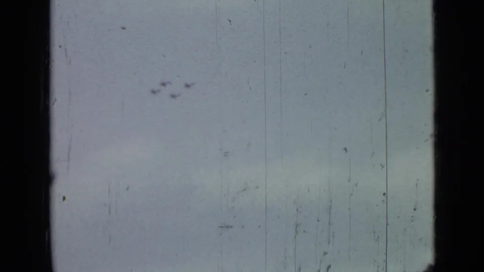 1967 Saint Petersburg 8mm frame with small aircraft silhouettes against a faded sky and visible film wear.