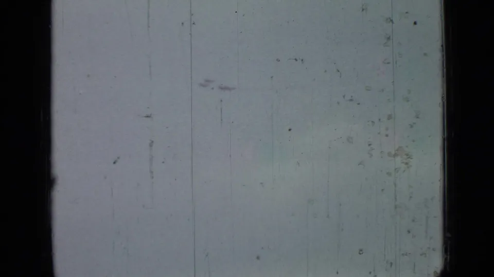 1967 Saint Petersburg airshow frame with faint aircraft silhouettes near the top of a worn 8mm sky shot.