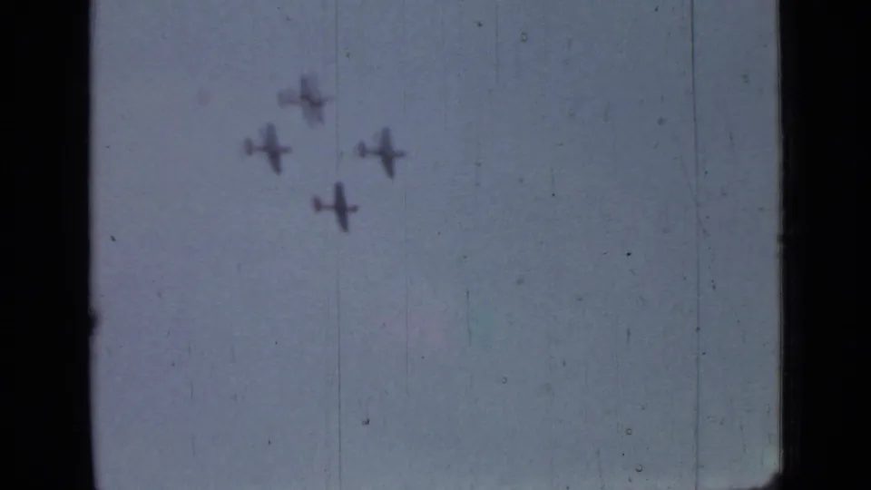 1967 Saint Petersburg airshow frame with four blurred planes grouped in formation on faded 8mm film.