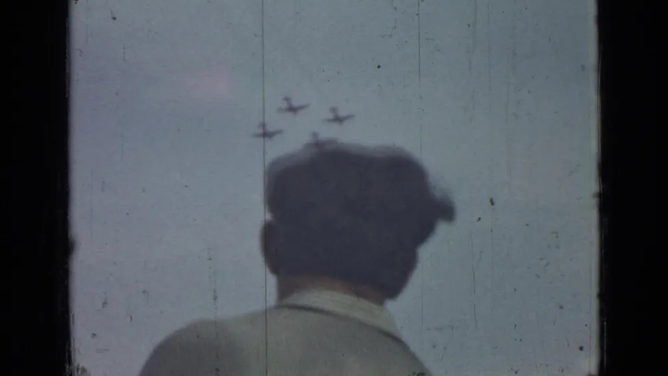 A silhouetted viewer stands below the aircraft formation in the final 1967 Saint Petersburg frame.