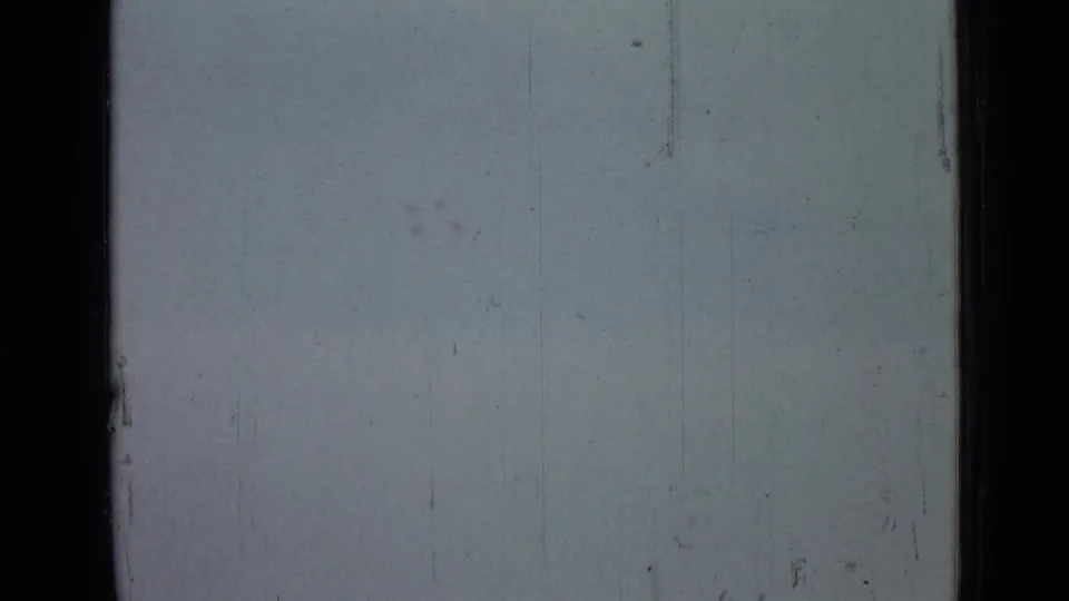 Washed-out sky area in the 1967 Saint Petersburg metadata clip, showing 8mm frame edges, scratches, dust marks, and uneven exposure.