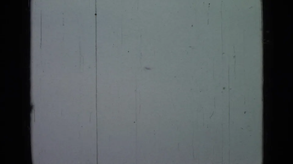 The final frame shows mostly pale sky, faint debris marks, and vertical 8mm scratches without identifiable people or landmarks.