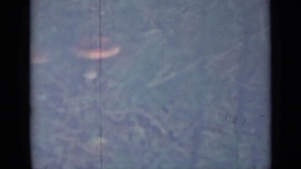 1967 Saint Petersburg 8mm frame with one prominent pink-capped mushroom in a faded grassy field.