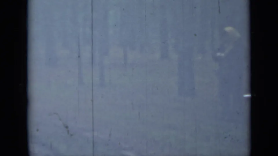 A hazy final frame shows the person and open trunk barely visible in the 1967 Saint Petersburg 8mm home-movie shot.