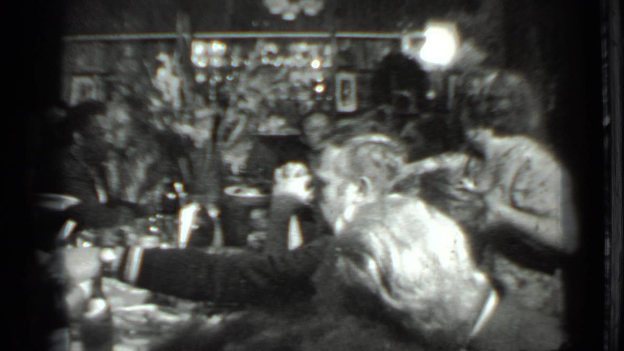 Adults seated around a crowded restaurant table with plates and bottles.