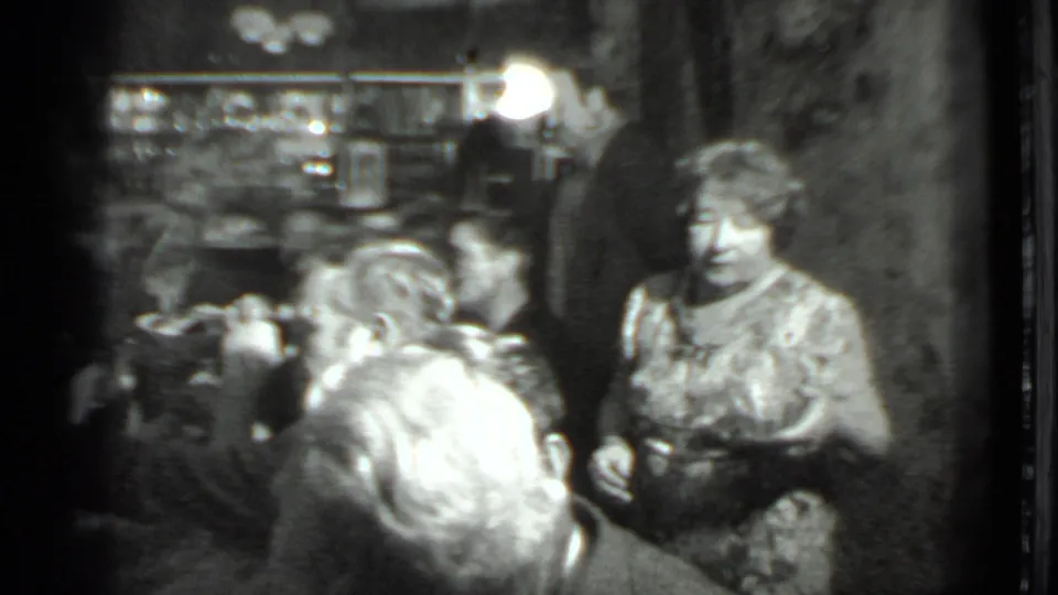 1975 Moscow restaurant scene with a waitress beside seated diners during a crowded dinner gathering.