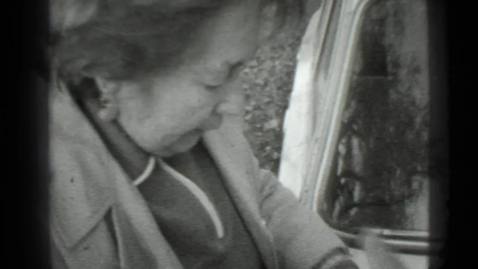In the Moscow 1975 clip, the woman leans close to the car door, her face and earring visible in profile.